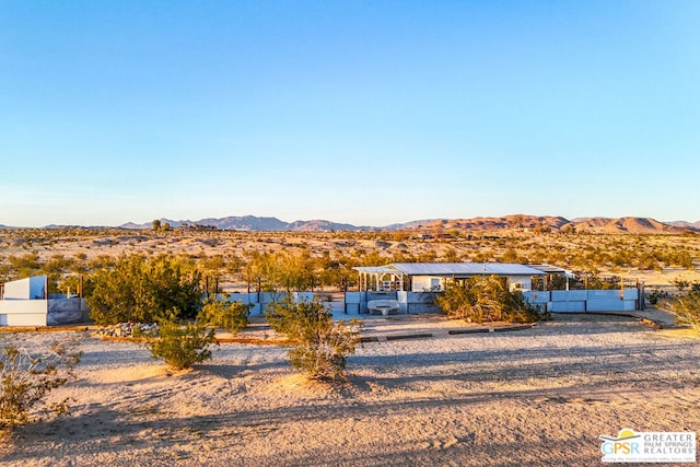 view of front of home with a mountain view and solar panels