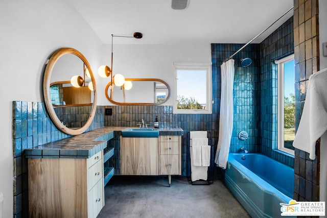 bathroom featuring vanity, tile walls, shower / bath combo, concrete floors, and decorative backsplash