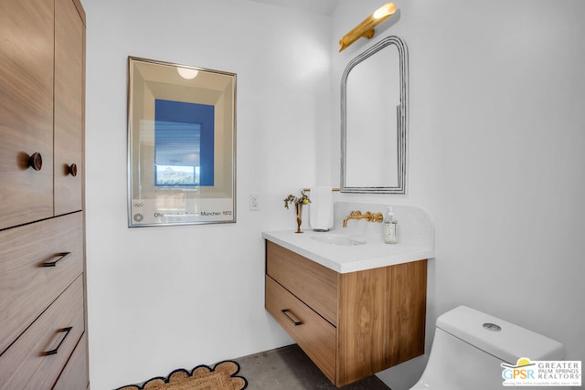 bathroom with toilet and vanity