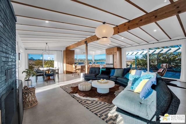 living room featuring concrete floors and vaulted ceiling with beams