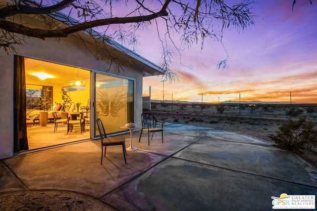 view of patio terrace at dusk