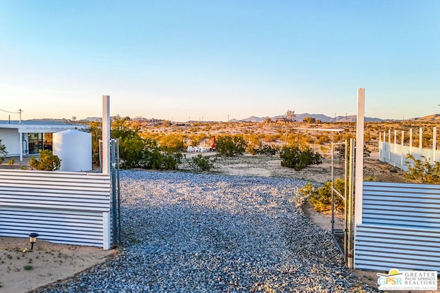 yard at dusk featuring a mountain view