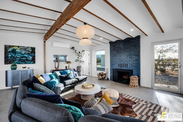 living room featuring an AC wall unit, a brick fireplace, a wealth of natural light, and concrete flooring