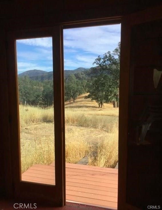 doorway to outside with a rural view and a mountain view