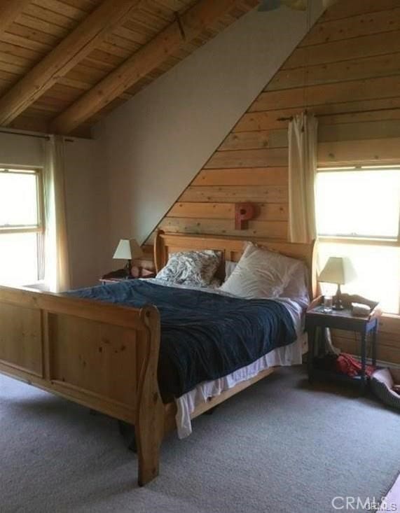 carpeted bedroom featuring wooden ceiling, wood walls, and lofted ceiling with beams