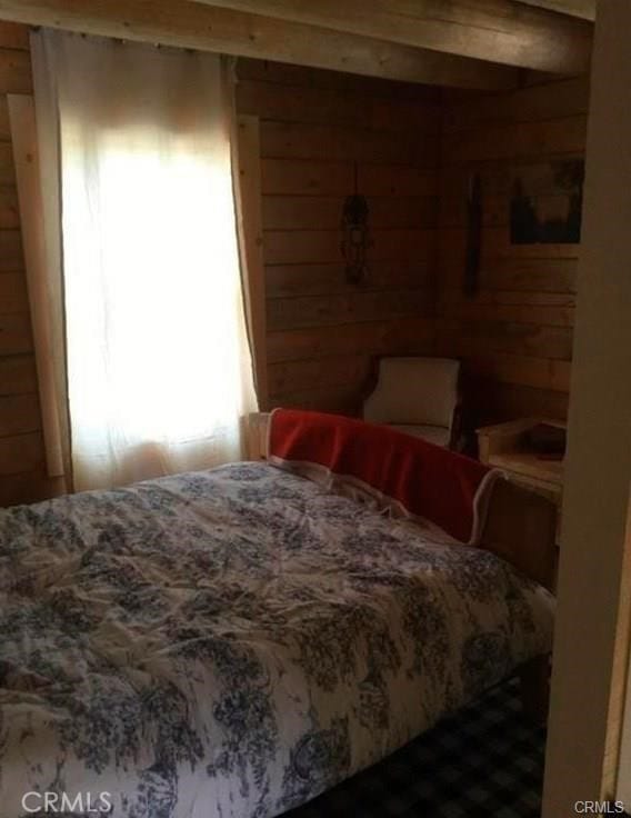 bedroom with wood walls