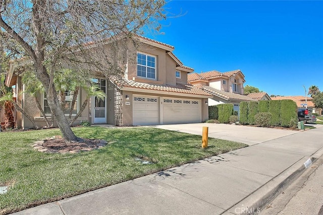 mediterranean / spanish-style house featuring a front lawn and a garage