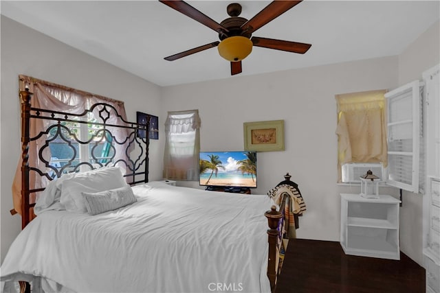 bedroom with ceiling fan and dark wood-type flooring