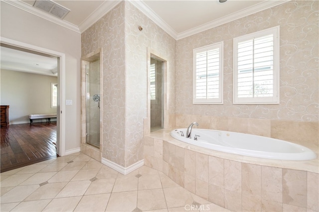 bathroom featuring ornamental molding, plus walk in shower, and hardwood / wood-style floors