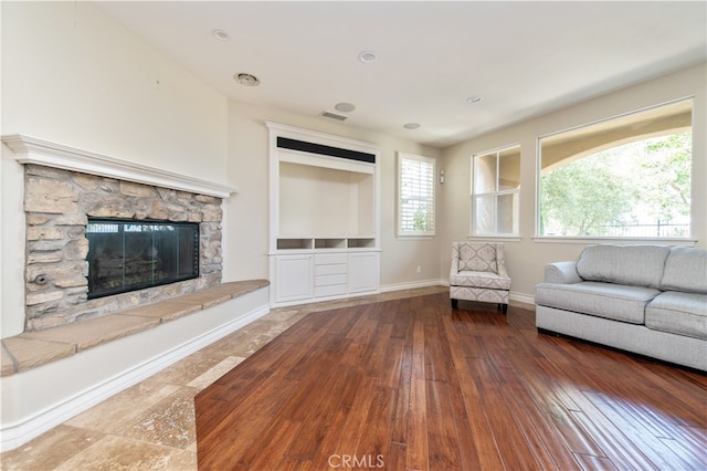 unfurnished living room featuring wood-type flooring and a fireplace