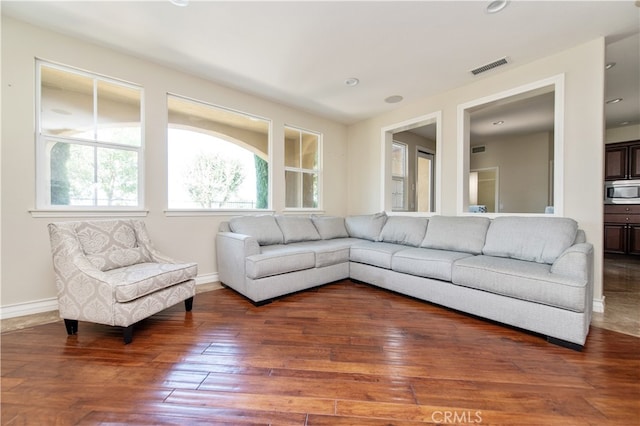 living room with dark hardwood / wood-style flooring