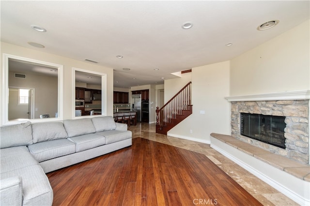 unfurnished living room with wood-type flooring and a fireplace