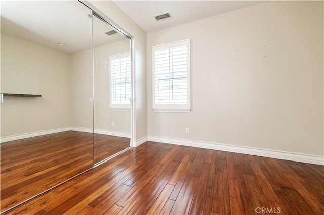 unfurnished bedroom with hardwood / wood-style flooring