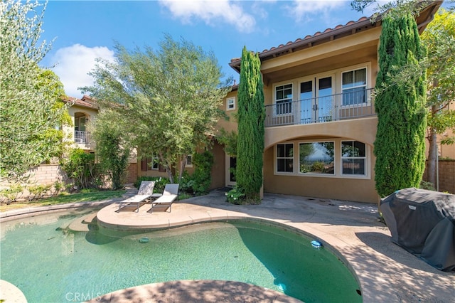 view of pool featuring a patio and area for grilling