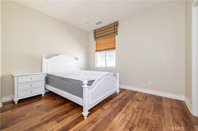 bedroom with dark wood-type flooring