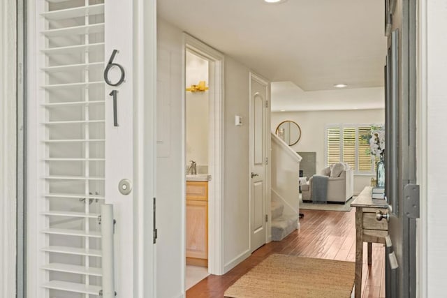 corridor with sink and hardwood / wood-style flooring