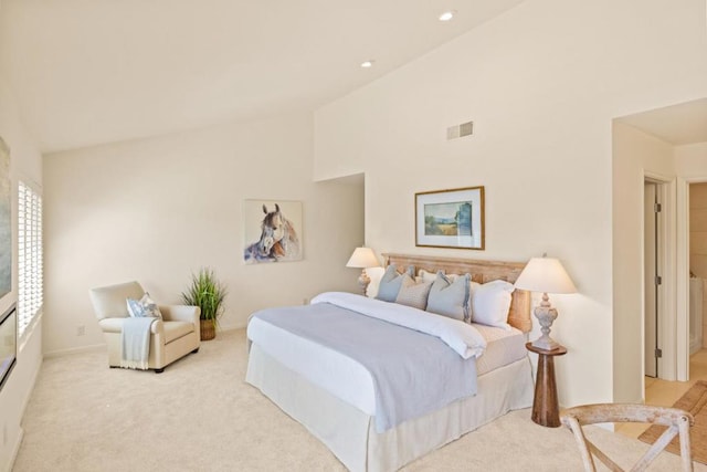 bedroom with high vaulted ceiling and light colored carpet