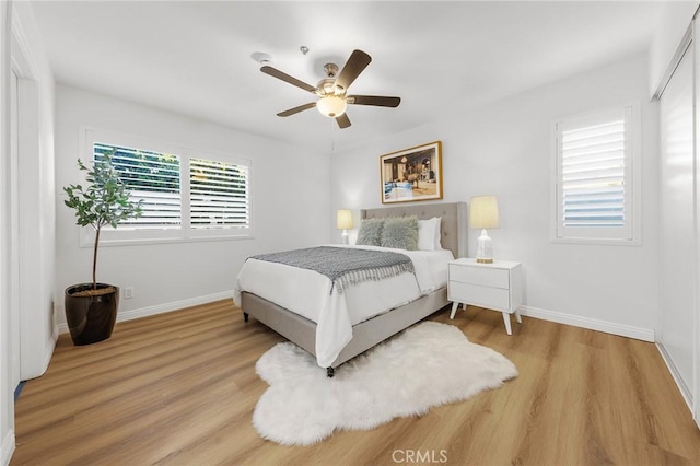 bedroom with ceiling fan and light hardwood / wood-style flooring