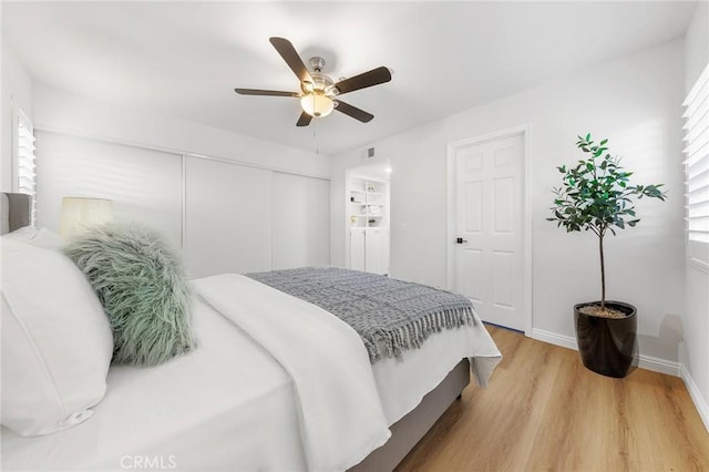 bedroom with hardwood / wood-style floors, a closet, and ceiling fan