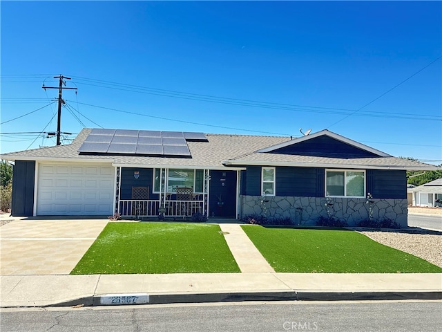 single story home featuring a front yard, a garage, and solar panels