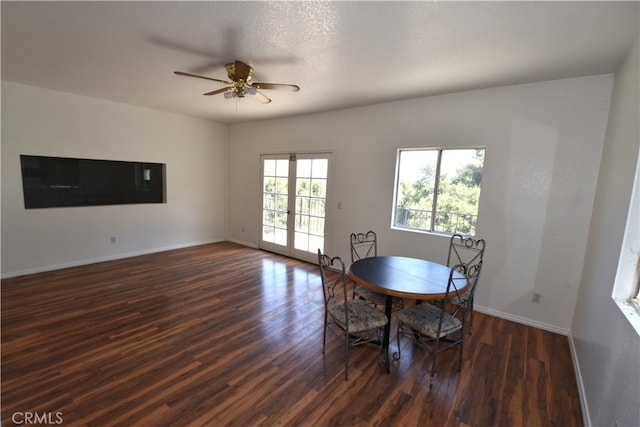 dining space with a textured ceiling, ceiling fan, and dark hardwood / wood-style flooring