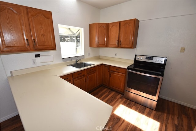 kitchen featuring stainless steel range with electric stovetop, dark wood-type flooring, and sink