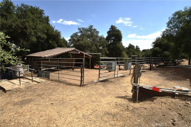 view of stable with a rural view