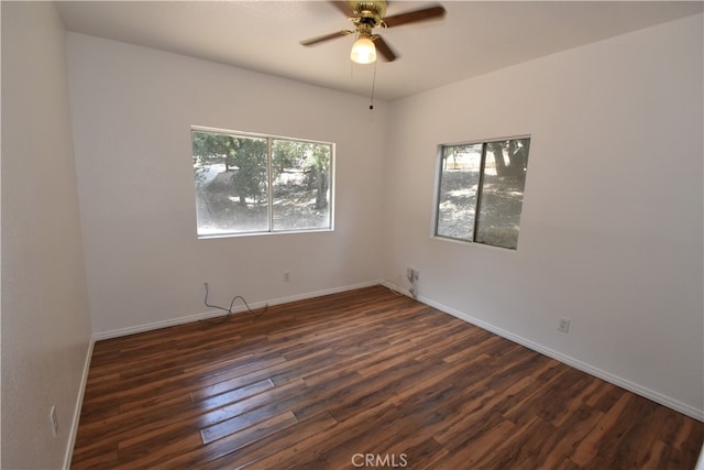 unfurnished room featuring ceiling fan and dark wood-type flooring