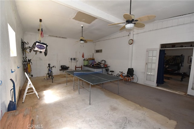 game room featuring ceiling fan, vaulted ceiling, and concrete flooring