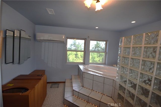 bathroom with tiled bath and a wall unit AC