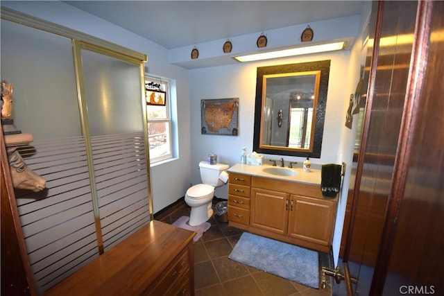 bathroom featuring tile patterned floors, vanity, and toilet