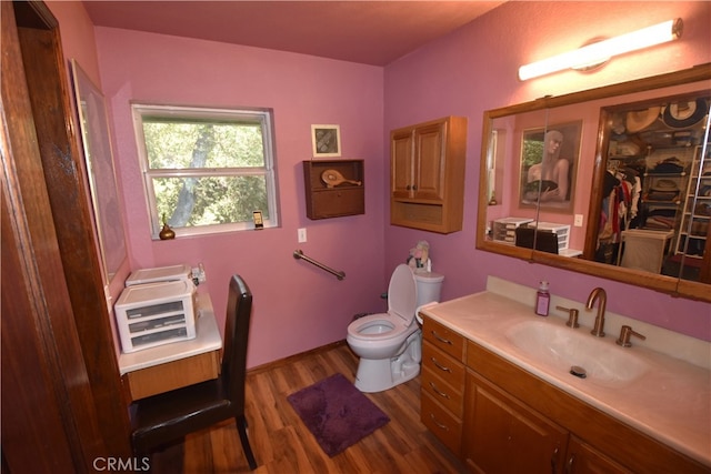 bathroom featuring hardwood / wood-style floors, vanity, and toilet