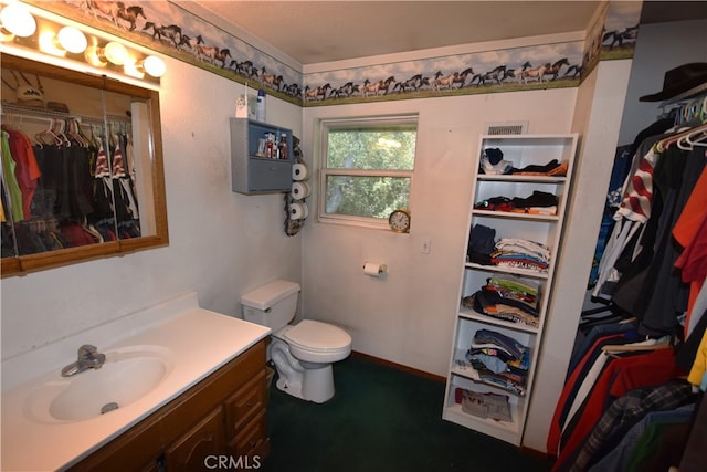 bathroom featuring vanity and toilet