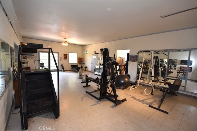 exercise room with ceiling fan