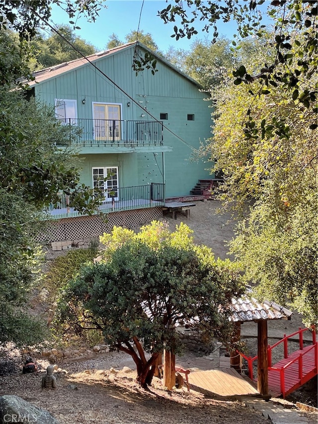 view of home's exterior with a balcony and a deck