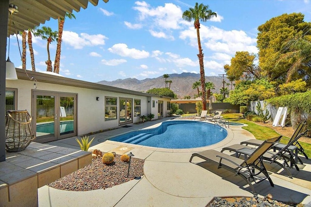 view of pool with a mountain view and a patio