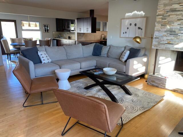 living room with light hardwood / wood-style flooring and sink