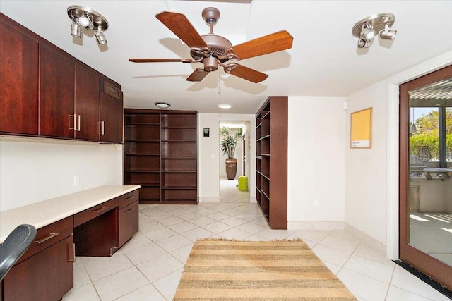 kitchen featuring ceiling fan, built in desk, and light tile patterned floors