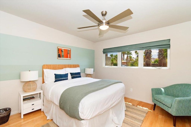 bedroom with ceiling fan and light wood-type flooring