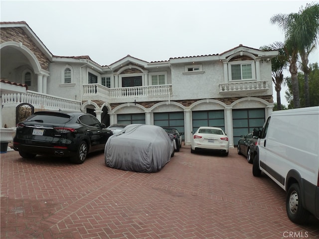 view of front of property with a balcony and a garage