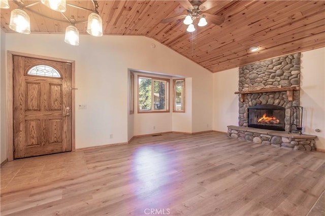 unfurnished living room with ceiling fan, wooden ceiling, a stone fireplace, light hardwood / wood-style floors, and lofted ceiling