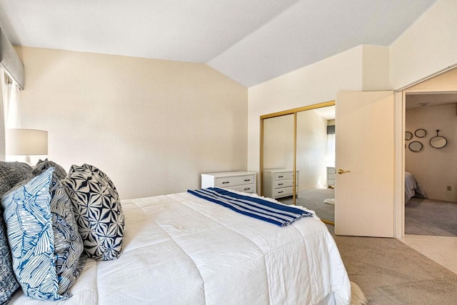 bedroom with carpet floors, multiple windows, a closet, and lofted ceiling