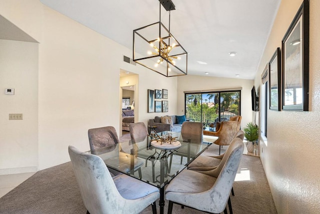 dining area featuring light carpet, vaulted ceiling, and a chandelier