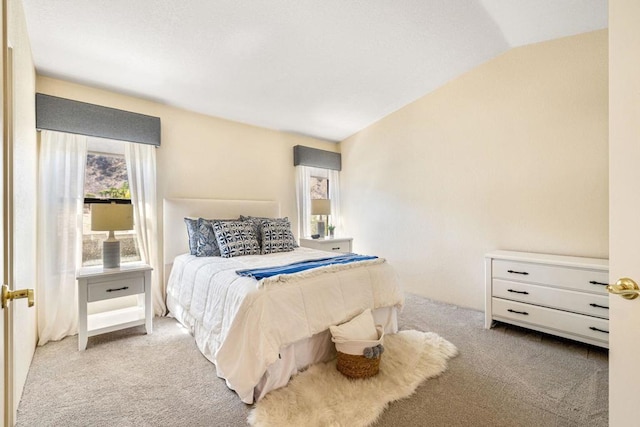 carpeted bedroom featuring vaulted ceiling