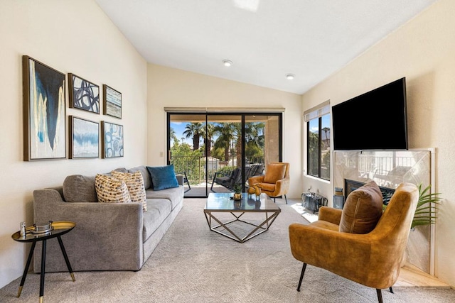 carpeted living room featuring vaulted ceiling and a tile fireplace