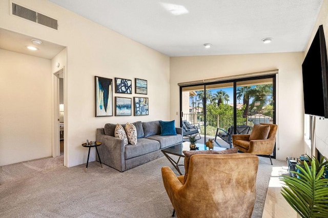 living room featuring lofted ceiling and light carpet