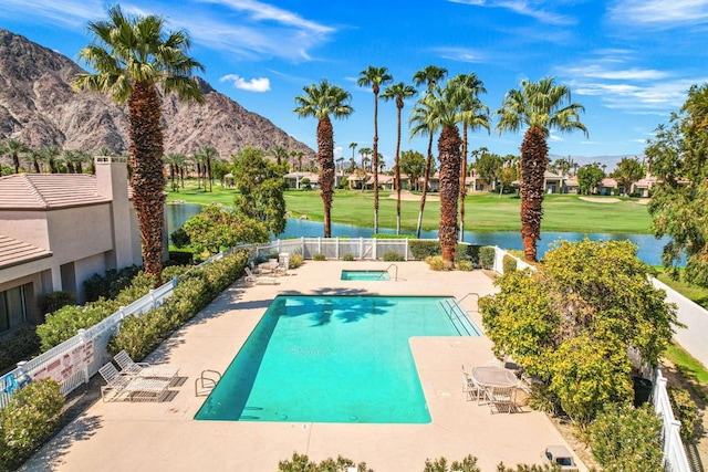 view of swimming pool featuring a patio area and a water and mountain view