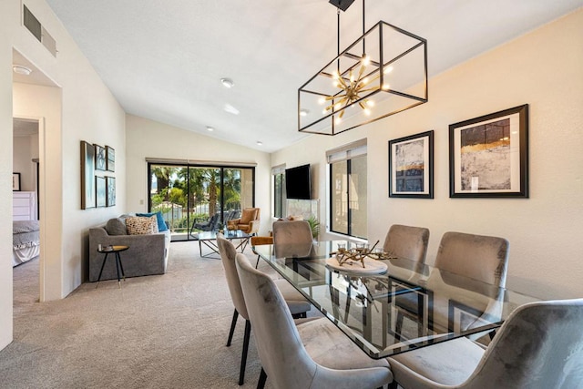 dining area with light carpet and vaulted ceiling