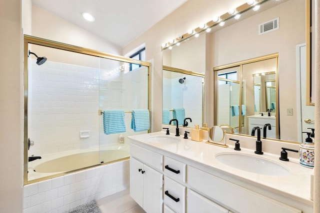 bathroom with lofted ceiling, vanity, tile patterned floors, and shower / bath combination with glass door