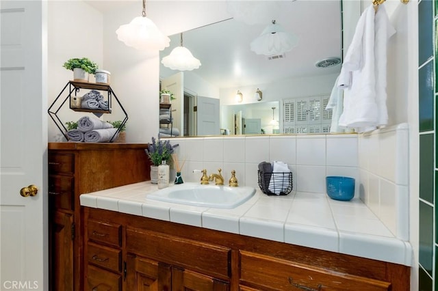 bathroom with tasteful backsplash and vanity